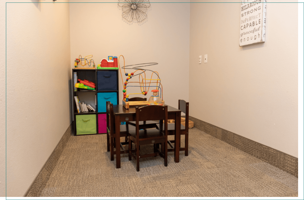 Kids area with bookshelf and small table with toys