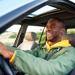 Man smiles while driving