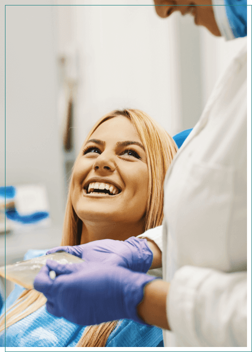 Woman in dental chair grinning at her Boise dentist