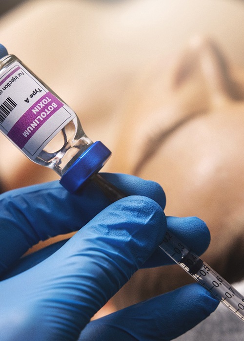 Gloved hand preparing BOTOX injection
