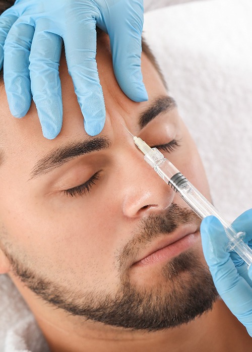 Man having BOTOX injection placed between brows