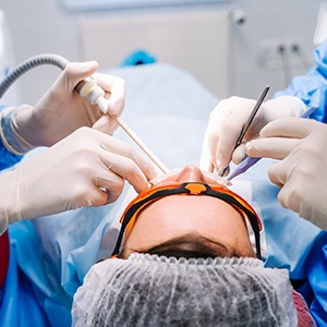 closeup of dentists doing work in a patient’s mouth