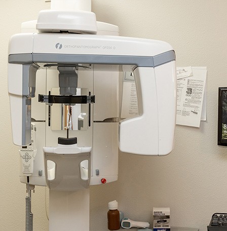 Cone beam scanner against white wall of dental office