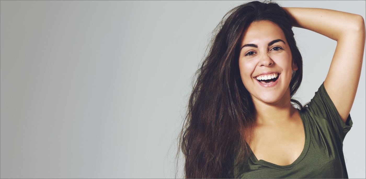 Young woman smiling after receiving dental services in Boise