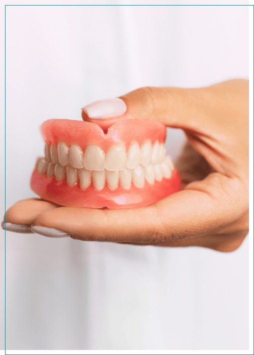 Dentist holding a set of full dentures