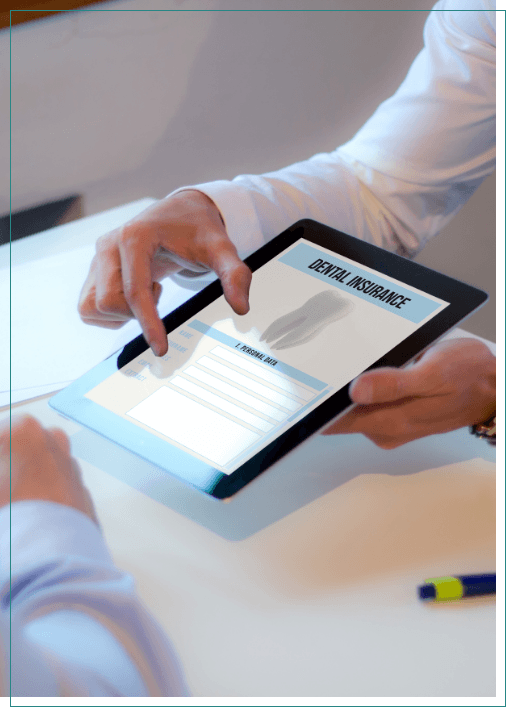 Two people looking at dental insurance information on a tablet