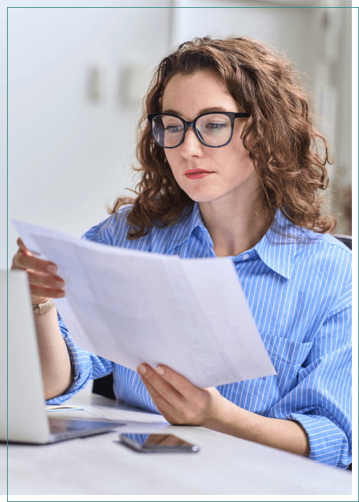 Woman at desk looking at paperwork