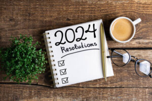 List on 2024 New Year’s resolutions on wooden table