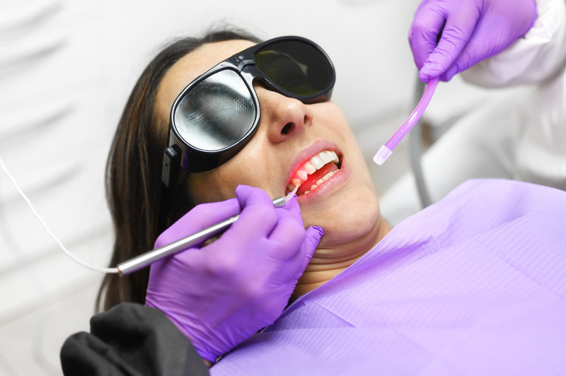 Patient getting gum disease treatment with dental laser