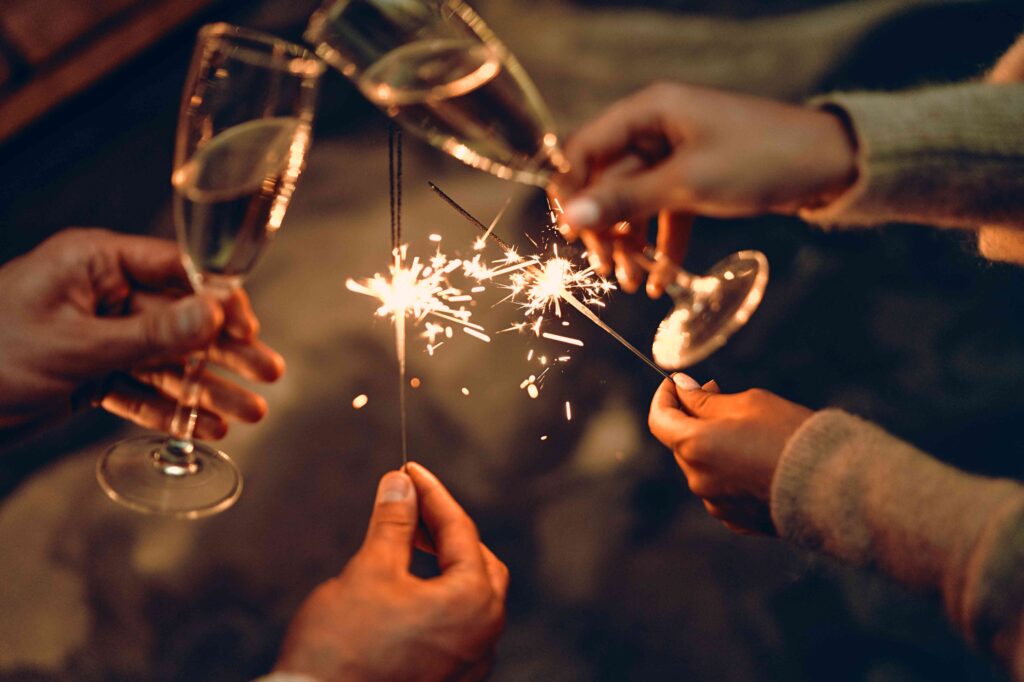 Couple holding champagne flutes and sparklers