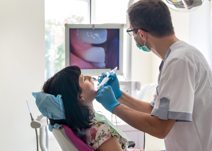Dentist performing exam with camera